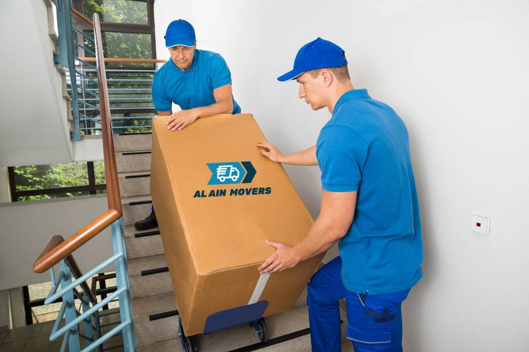 staff carefully navigating stairs with a large moving box